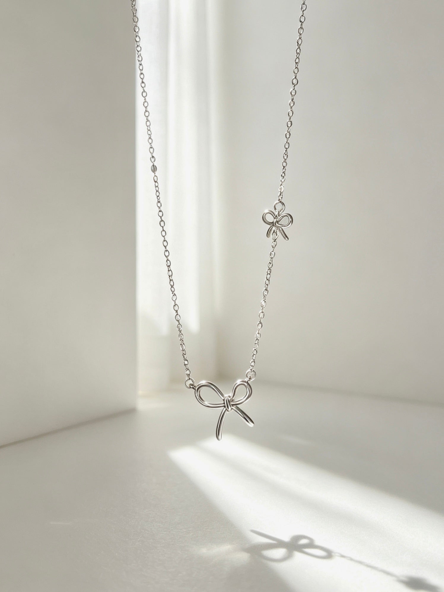 Twin Bow Pendant Necklace
